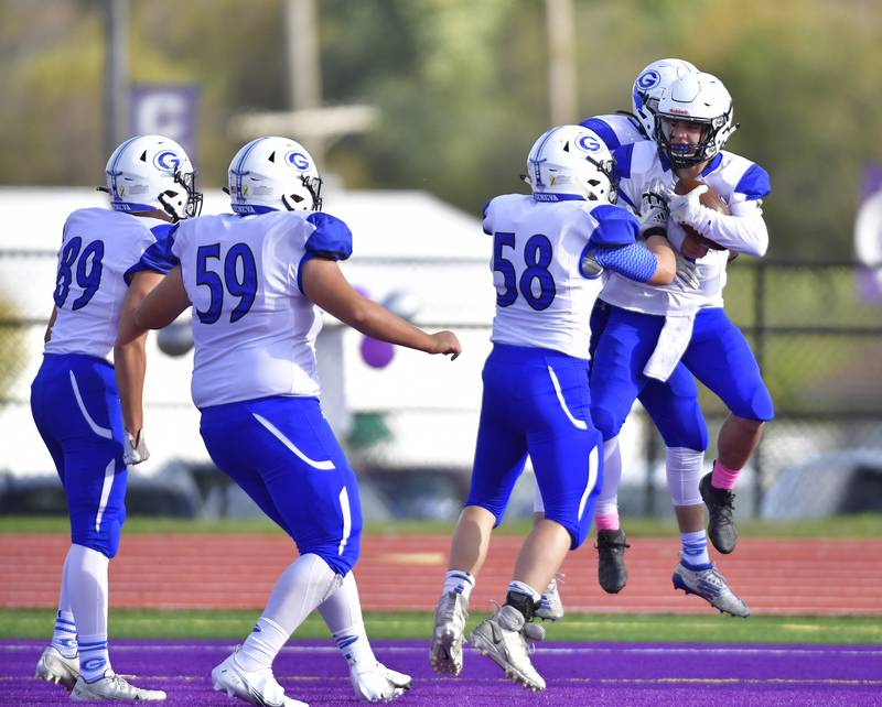 Geneva teammates run up to player Nate Stempowski (right) as they celebrate his touchdown. Geneva defeated Collinsville 28-2 in a Class 7A first-round football playoff game at Collinsville High School in Collinsville, IL on Saturday October 30, 2021.