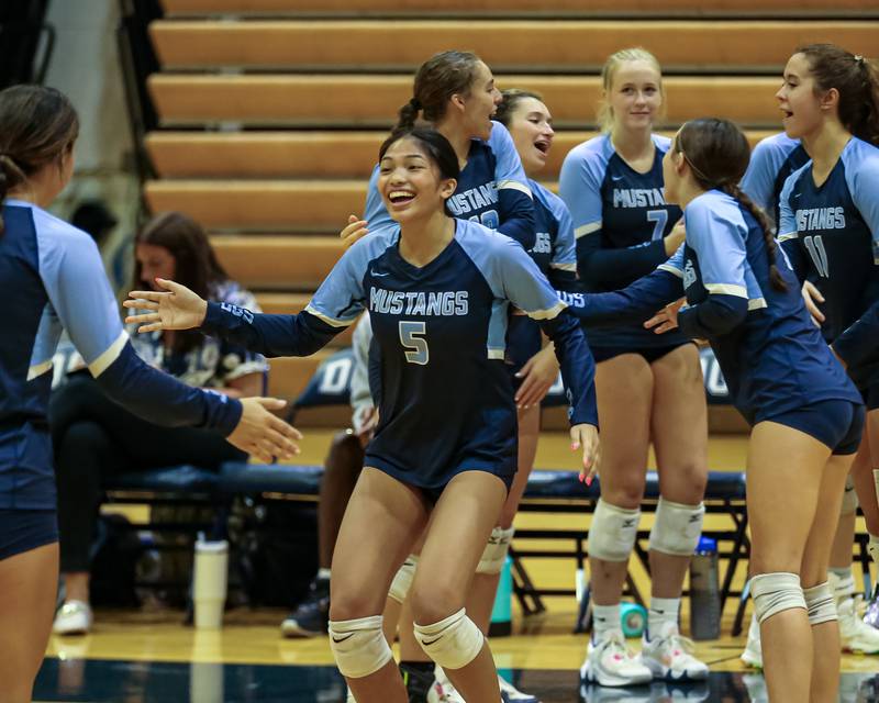 Downers Grove South's Ale Bacenas (5) runs out during pregame introductions before their volleyball match at Downers Grove South.  Sept 7, 2023.