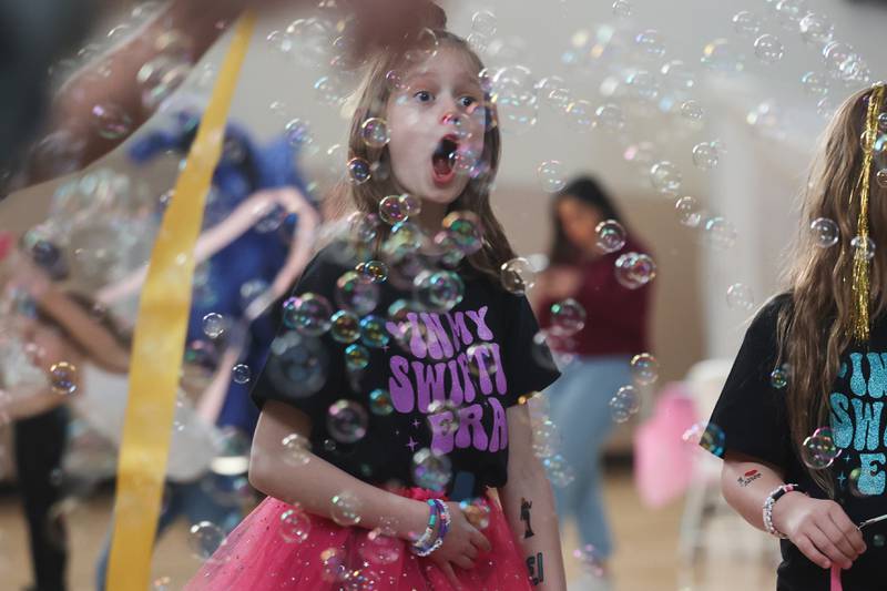 Maeve Olson, 8-years old, reacts to seeing “Taylor Swift” at the Taylor Swift fan party hosted by the Lockport Township Park District on Saturday, Feb. 10, 2024 in Lockport.
