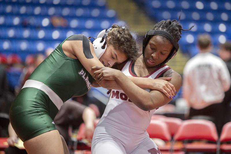 Alicia Tucker of Plainfield Central (left) and Maryam Ndiaye of Moline grapple during the 155-pound championship match at the IHSA Girls Wrestling State Finals on Saturday, Feb. 25, 2023. Tucker captured the championship in the closing seconds.