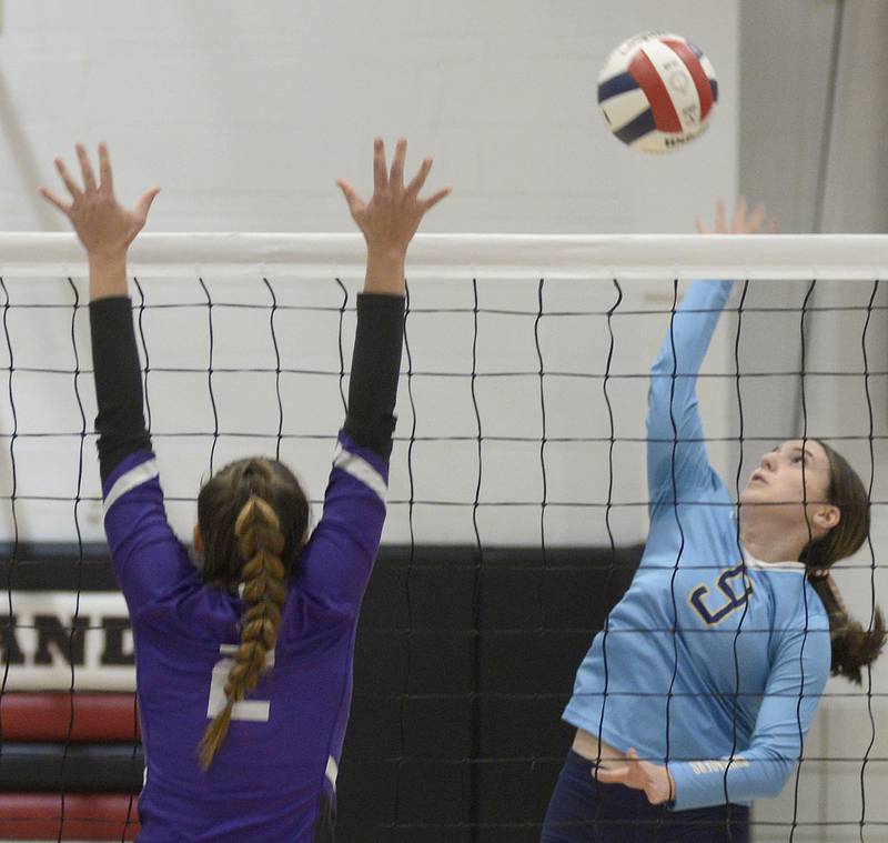 Marquette’s Makayla Backos sets up to tip the ball past Lexington’s Emma Bennett  during the 2nd set Tuesday at the Woodland Sectional.