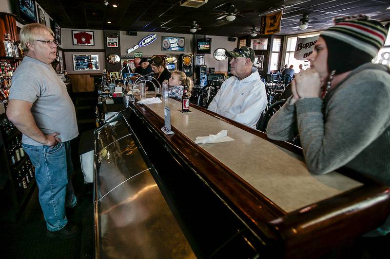 John Schneider (left) talks with his son Zach Schneider (right), and Paul Milanko (center) on Friday at Bopp’s Tavern in Harvard. The elder Schneider is father of Harvard Hornets quarterback Peyton Schneider, and Milanko is father of Hornets offensive tackle Anthony Milanko. The Hornets completed their fifth undefeated regular season in school history this year.