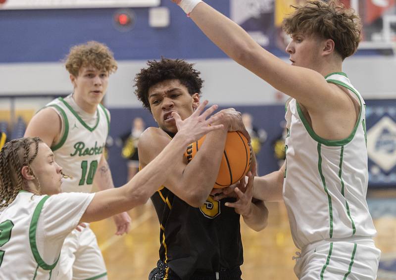 Riverdale’s Aris Morgan handles the ball against Rock Falls’ Nehemiah Menendez (left) and Cole Mulnix Friday, Feb. 28, 2025, during the Class 2A Regional final at Bureau Valley High School.