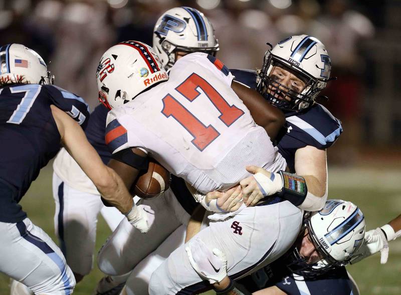 A host of Prospect players bring down St. Rita's Dj Stewart (17) during the second round of the IHSA Class 7A Playoffs Friday November 4, 2022 in Mount Prospect.