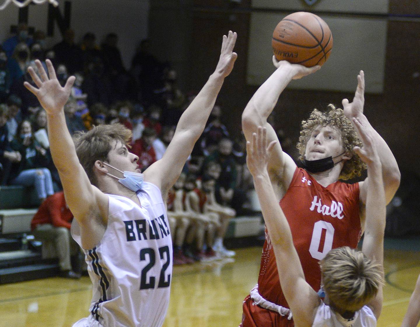 Hall’s Mac Resetich, (0) shoots over the St Bede defense of Luke Story, (22) and John Brady in the 1st period Tuesday at St Bede on Tuesday Jan. 18, 2022.