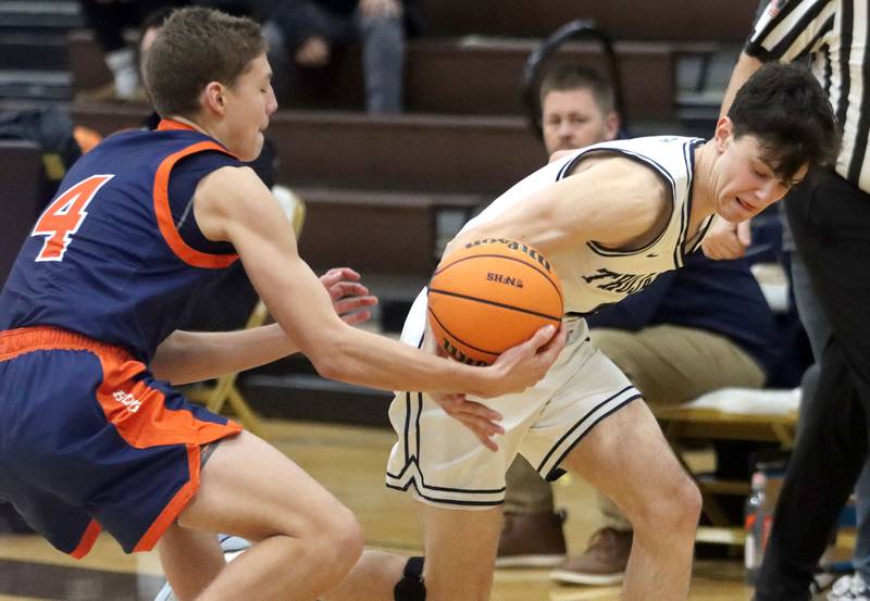 Naperville North’s Miles Okyne, left, steals the ball from Cary-Grove’s Dylan Dumele in varsity boys basketball Hinkle Holiday Classic action on Monday, Dec. 21, 2025, at Jacobs High School in Algonquin.