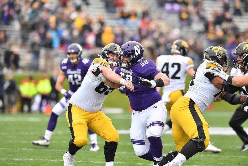 Northwestern defensive lineman Wyatt Blake takes on an Iowa lineman last season. Blake, a Crystal Lake Central graduate, will have to wait for the spring to play football as the Big Ten Conference pushed its fall sports back because of the COVID-19 pandemic.