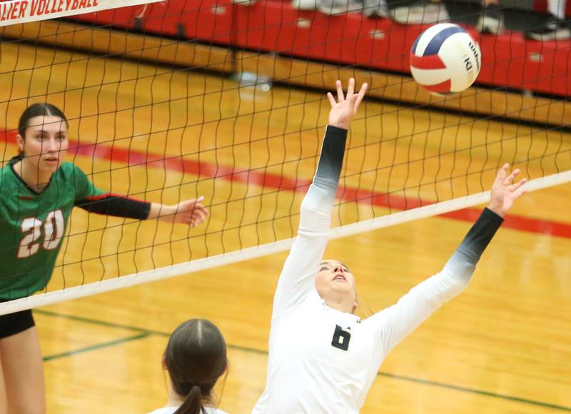 Sycamore's Lana Walker sets the ball in the air as L-P's Anna Riva eyes to block it on Tuesday, Oct. 15, 2024 in AJ Sellett Gymnasium at L-P High School.