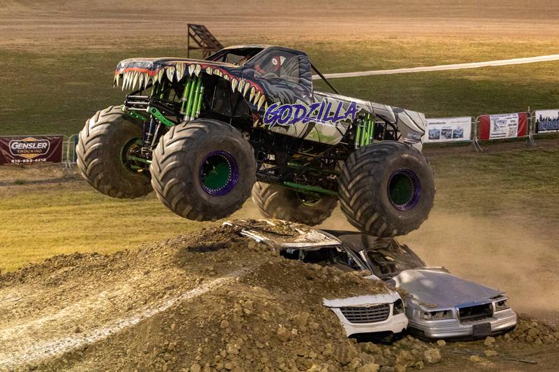 Ryan Holman drives Monster Truck 'Godzilla' over 2 cars during the Monster Truck Bash on Saturday, Sept. 13, 2025 at the La Salle Speedway in La Salle.
