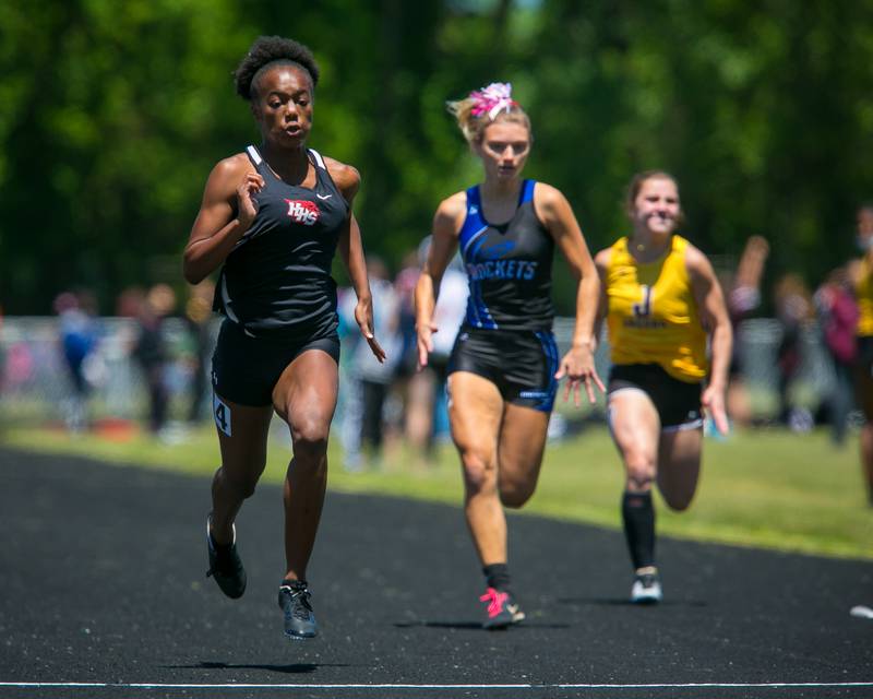 Huntley's Alex Johnson, left, wins the 100 meters at the 2021 Fox Valley Conference Girls Track and Field Meet last season in 12.54 seconds.