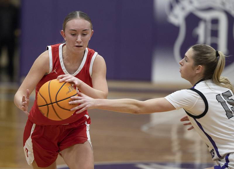 Ottawa’s Ashlynn Ganiere handles the ball against Dixon’s Morgan Hargrave Wednesday, Dec. 4, 2024, at Dixon High School.