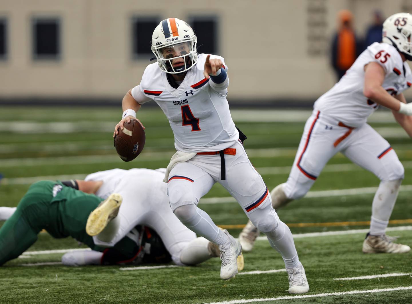 Oswego's Drew Kleinhans (4) directs traffic during the varsity football second-round 8A playoff game between Oswego and Lane Tech on Saturday, Nov. 8, 2025 in Chicago.