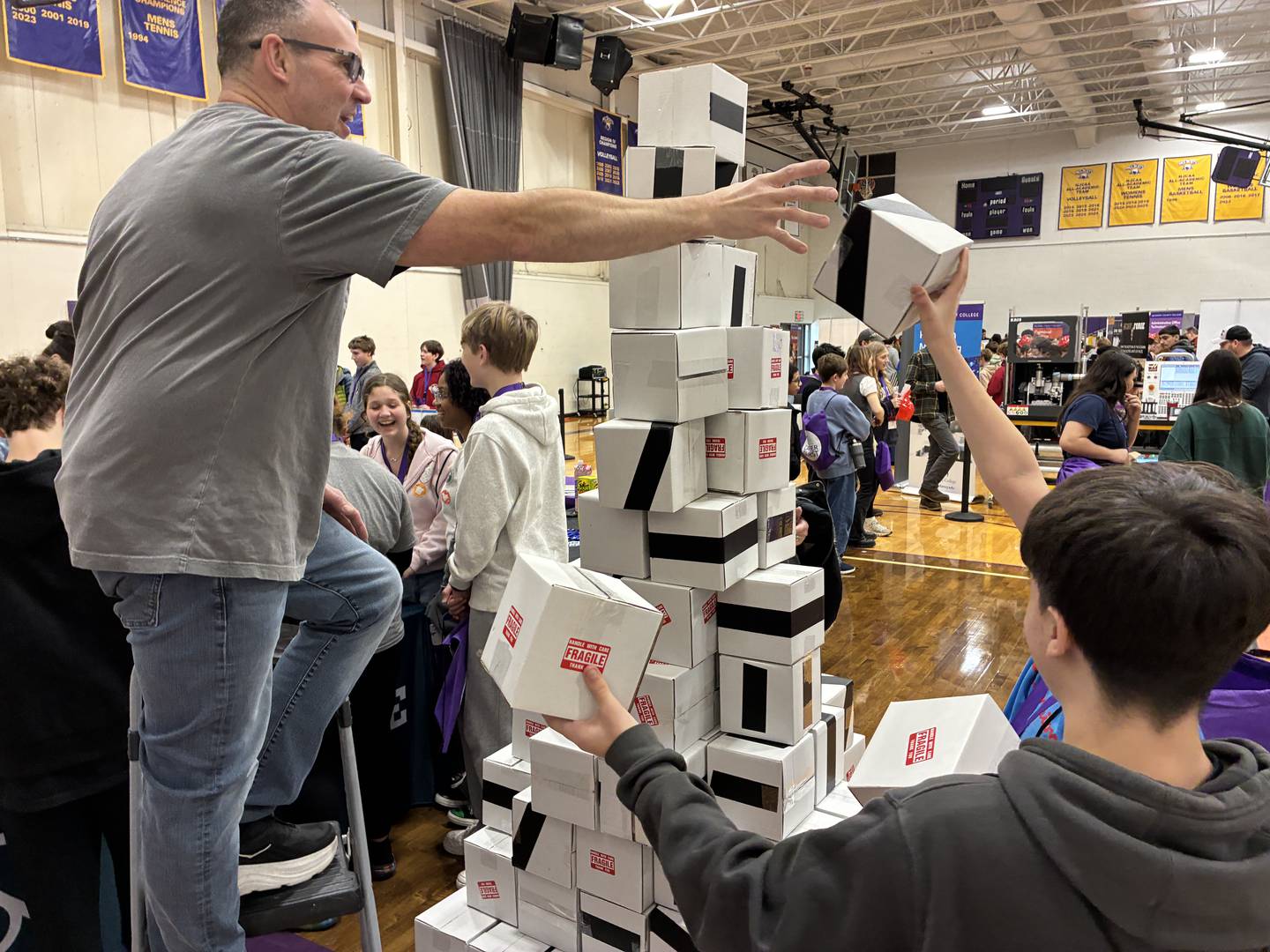 Students helped to stack, and then knock over, boxes on Friday, March 13, 2026, at the annual MCC Middle School Career Quest.