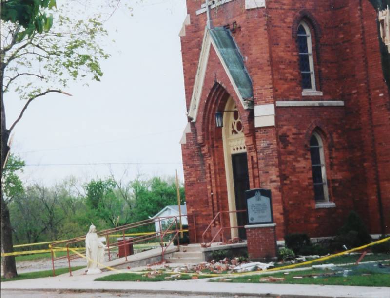 A view of the tornado damage at St. Mary's Catholic Church on Wednesday April 21, 2004 in Utica. The statue of St. Mary was blown off of the pedestal by the tornado and Msgr. James Swaner lifted it up from the ground.