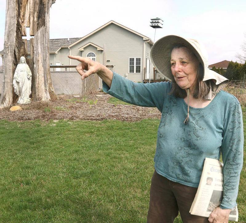Standing near a Mary statue in a hollowed out tree that was taken down by the tornado Susan Meyer talks Wednesday at her home in Fairdale, about what she saw and heard April 9, 2015 when the tornado ripped through the town destroying her home, along with many others, and killing two people. Thursday marks the five year anniversary of the tornado that ripped through parts of Fairdale, Rochelle and Kirkland.