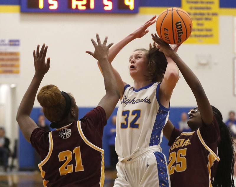 Johnsburg's Skye Toussaint tries to shoot the ball between Chicago Marshall's Alysha Murphy (left) and Chamarre Scott (right) during a IHSA Class 2A Johnsburg Sectional girls basketball semifinal game on Tuesday, February, 24, 2026, at Johnsburg High School.