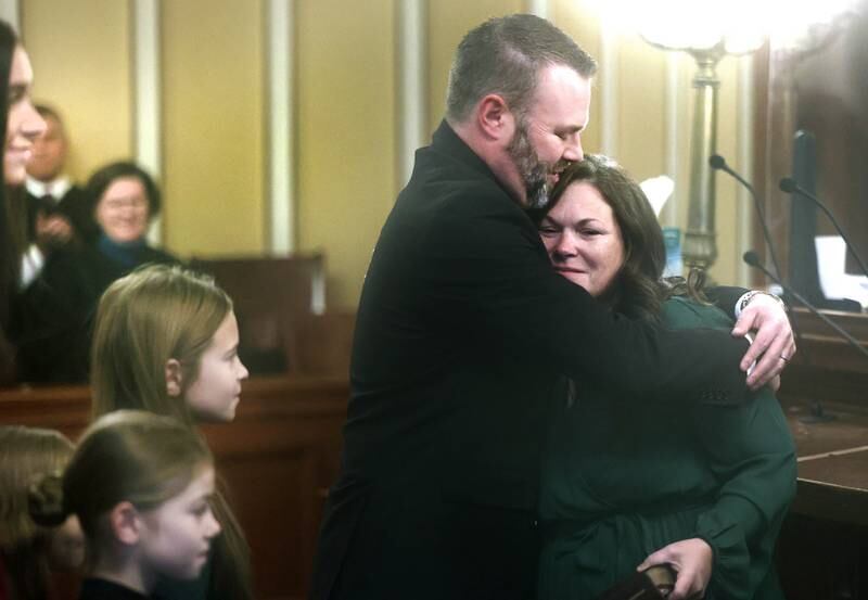 New DeKalb County State’s Attorney Riley Oncken hugs his wife Heather after being sworn into office by Chief Judge Bradley Waller Monday, Dec. 2, 2024, at the DeKalb County Courthouse in Sycamore.