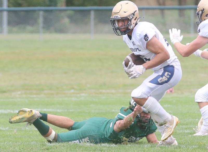 Marquette's Payton Gutierrez gets a few extra yards as St Bede's Logan Pineda misses the tackle during the Homecoming game on Saturday, Sept. 28, 2024 at St. Bede Academy.