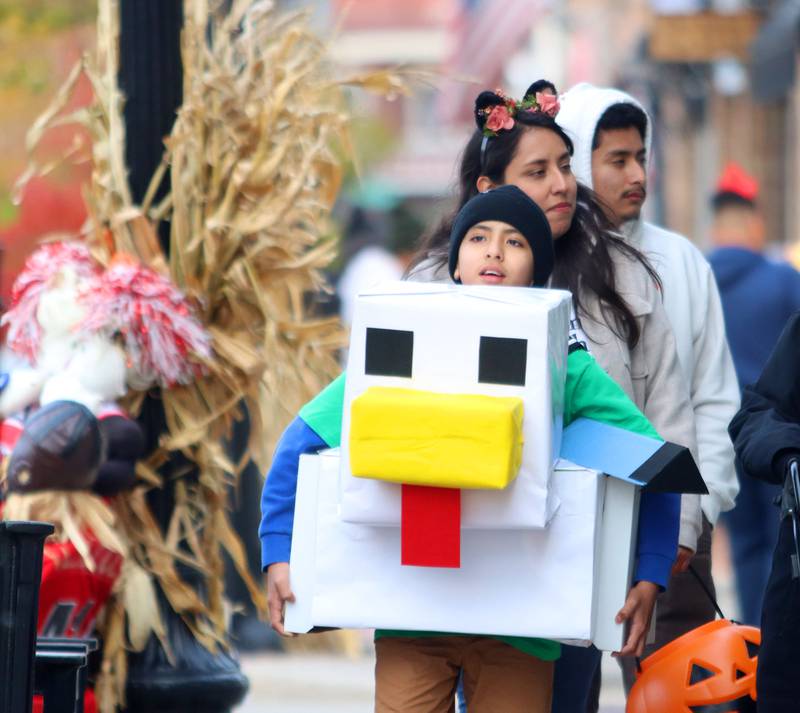 Gael Vargas, 11, of Crystal Lake navigates downtown Crystal Lake in his Minecraft costume while trick-or-treating  on Friday, October. 31, 2025