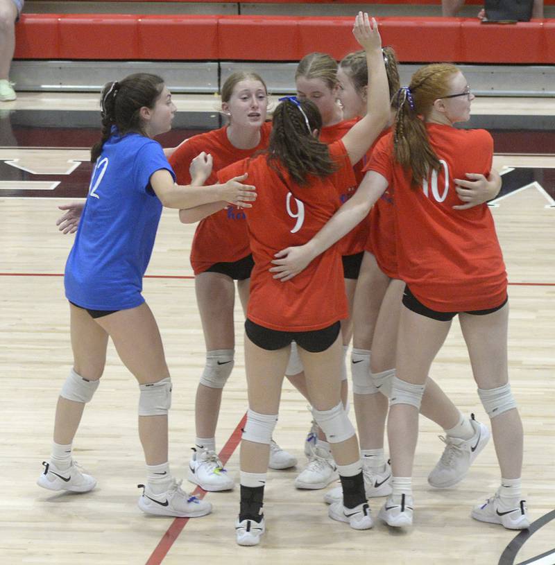The Woodland Warriors gather to celebrate a point late in the opening set Tuesday, Sept. 5, 2023, at the Warrior Dome.