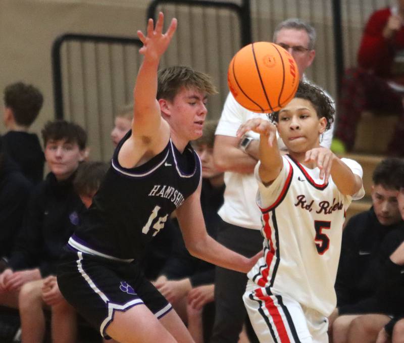Huntley’s  Jalen Howard, right, passes as Hampshire’s Tyler Lacke defends in varsity boys basketball on Friday, Dec. 19, 2025, at Huntley High School in Huntley.