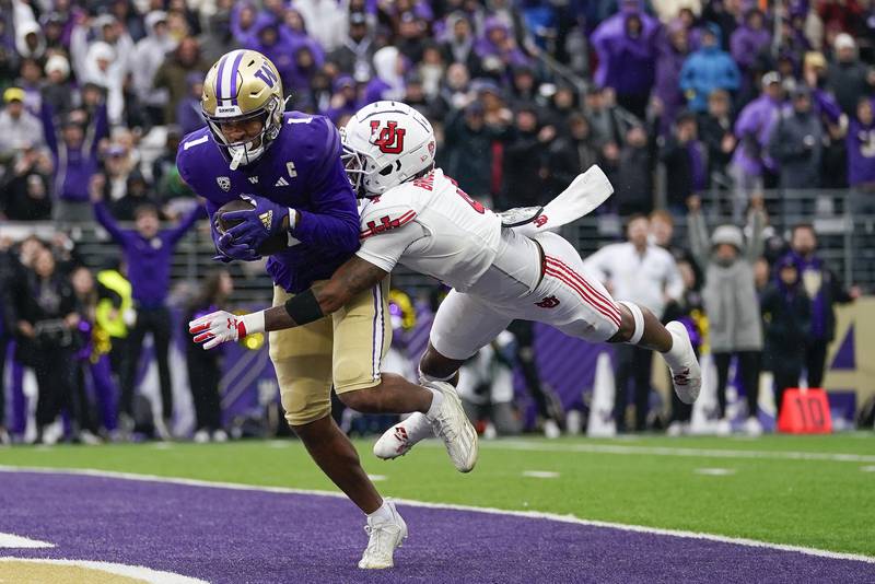 FILE - Washington wide receiver Rome Odunze (1) makes a catch for a touchdown against Utah cornerback JaTravis Broughton (4) during the second half of an NCAA college football game Saturday, Nov. 11, 2023, in Seattle. Washington won 35-28. Odunze is a possible first round pick in the NFL Draft.(AP Photo/Lindsey Wasson, File)