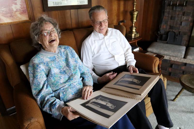 Rosemarie and Lloyd Lesmeister, both 93, flip through their wedding book from 1947 as they pose for a portrait on Friday, April 9, 2021, at their home in Crystal Lake.  The couple got married at 19 and will be celebrating their 74th anniversary this year.