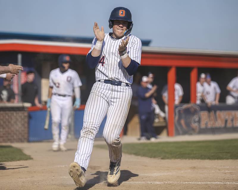 Oswego's Drew Kleinhans (4) scores a run during baseball game Oswego East at Oswego.  May 14, 2026 in Oswego.