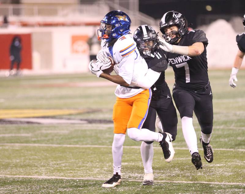 East St. Louis's Amir Tillman runs the ball past Fenwick's Jake Thies during the Class 6A State championship game on Tuesday, Dec. 2, 2025 in Hancock Stadium at Illinois State University in Normal.