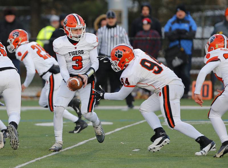 Byron's Braden Smith (3) hands off the ball to Caden Considine during the Class 3A varsity football semi-final playoff game between Byron High School and IC Catholic Prep on Saturday, Nov. 19, 2022 in Elmhurst, IL.
