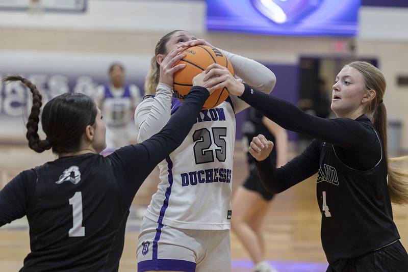 Dixon’s Presley Lappin looks to put up a shot against Kaneland’s Daniela Ridolfi (left) and Lillyana Crawford Wednesday, Dec. 10, 2025.