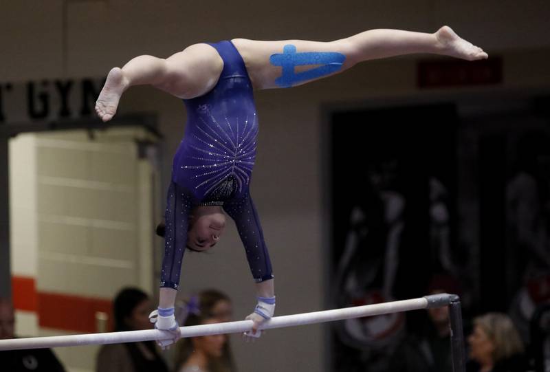 Downers Grove's Genevieve Herion competes in the preliminary round of the uneven parallel bars on Friday, Feb. 21, 2025, during the IHSA Girls State Final Gymnastics Meet at Palatine High School.