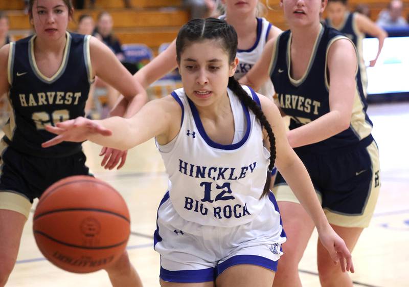 Hinckley-Big Rock’s Lilliana Martinez tries to save a ball from going out-of-bound in front of two Harvest Christian defenders Monday, Jan. 8, 2023, during their game at Hinckley-Big Rock High School.