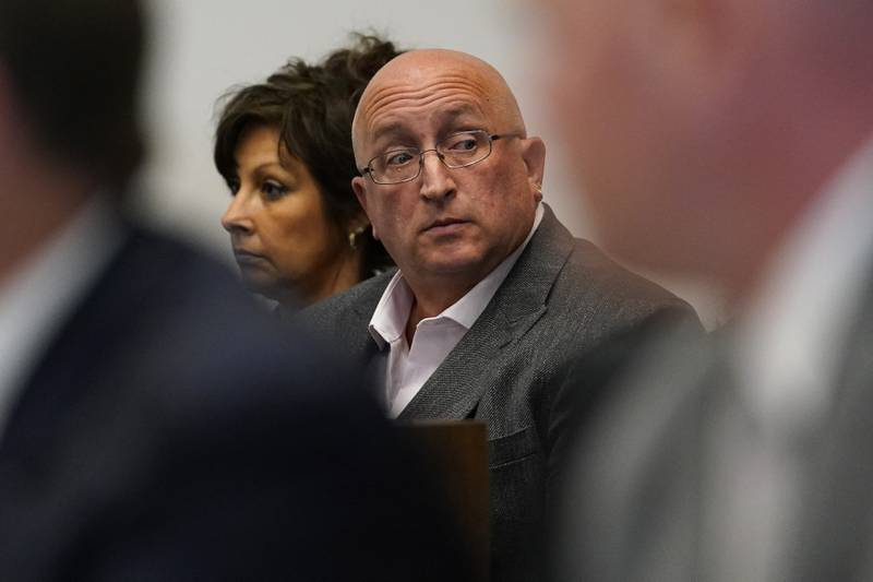 FILE - Robert E. Crimo III's father Robert Crimo Jr., right, and mother Denise Pesina attend to a hearing for their son in Lake County court on Aug. 3, 2022, in Waukegan. Prosecutors announced Friday, Dec. 16, that Crimo Jr., the father of the Illinois man charged with killing seven people in a mass shooting at a July 4 parade in a Chicago suburb, has been charged with seven felony counts of reckless conduct.