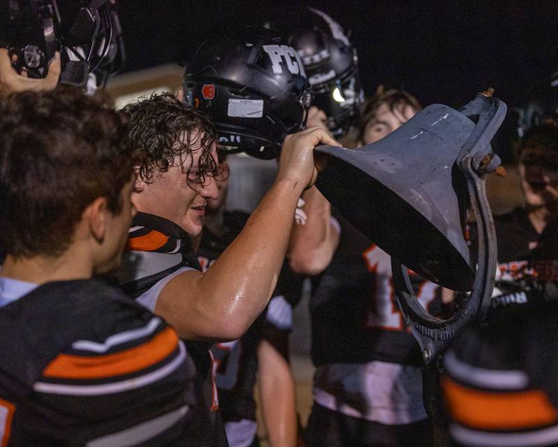 Leelynd Durbin (7) of Flanagan-Cornell/Woodland rings the victory bell after the Falcons' win on Friday, Sept. 26, 2025, at Woodland School in rural Streator.