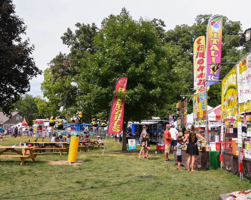 People visit food vendors at while others take on the carnival rides on Saturday Aug. 16, 2025, during Elburn Days held at Lions Park in Elburn.