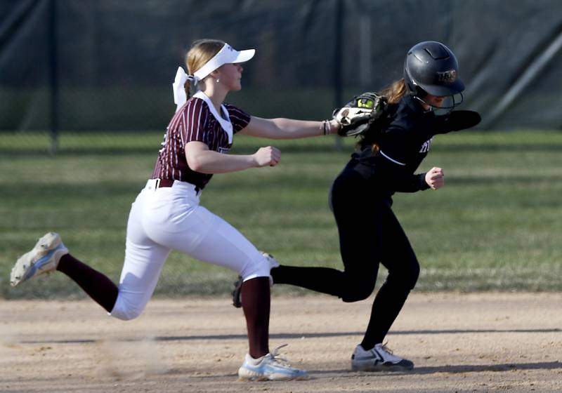 Prairie Ridge's Ady Kiddy tags out Huntley's Lana Hobday during a rundown between third and second bases during Fox Valley Conference softball game on Monday, April 14, 2025, at Prairie Ridge High School in Crystal Lake.