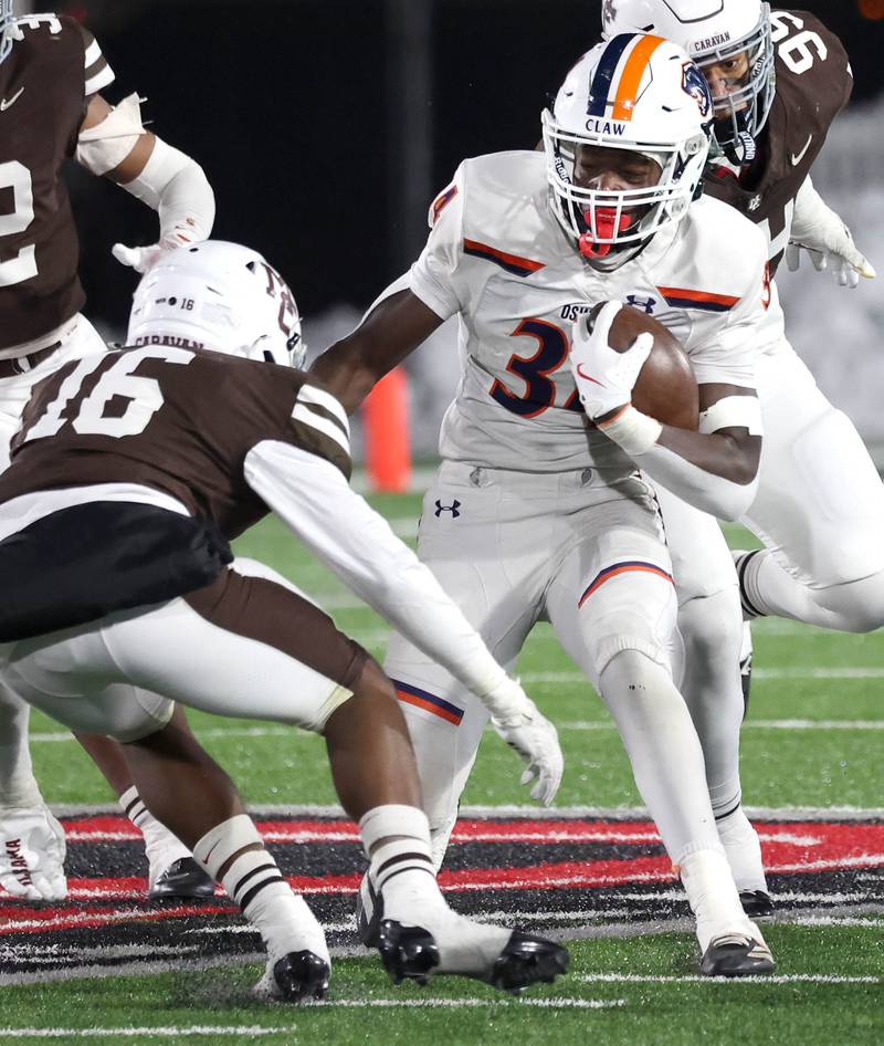 Oswego's Ammar Banire tries to get by Mount Carmel's Brandon Rogers Jr. Wednesday, Dec. 3, 2025, during their IHSA Class 8A state chamionship game in Huskie Stadium at Northern Illinois University in DeKalb.