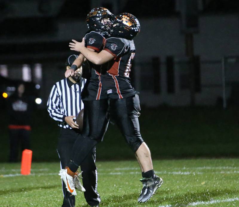 Flanagan-Cornell/Woodland's Kesler Collins chest bumps teammate Aydran Radke after scoring a touchdown over South Beloit during the first round of the 8-man football playoffs on Friday, Oct. 27, 2023 in Flanagan.