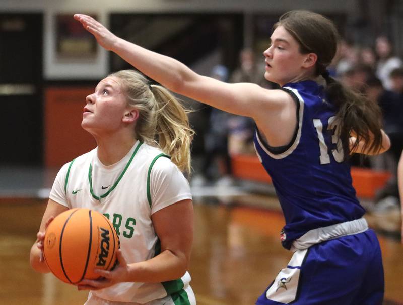 Crystal Lake South’s Laken LePage works past Geneva’s Linnea Popp in girls IHSA Class 3A Sectional Championship basketball on Thursday, Feb. 26, 2026, at Crystal Lake Central High School in Crystal Lake.
