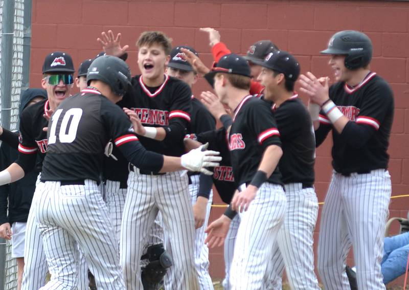 Fulton's Dom Kramer is met by his teammates after hitting a double in the first inning en route to a 7-4 win over Forreston at the 1A Amboy Regional on Saturday, May 24, 2025.