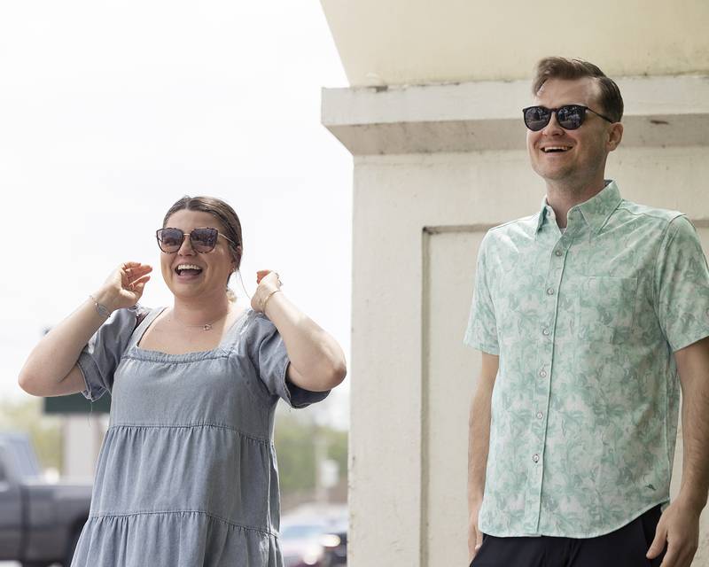 Emma Walsh and Riley Dixon smile as family members come in to celebrate after the surprise proposal Saturday, April 27, 2024.