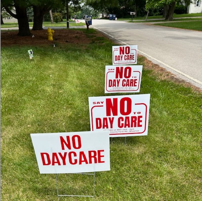 Signs protesting plans for a day care center to be built in an unincorporated area of DuPage County adjacent to Downers Grove line Maple Avenue. Residents say the center would generate too much traffic and poses safety risks