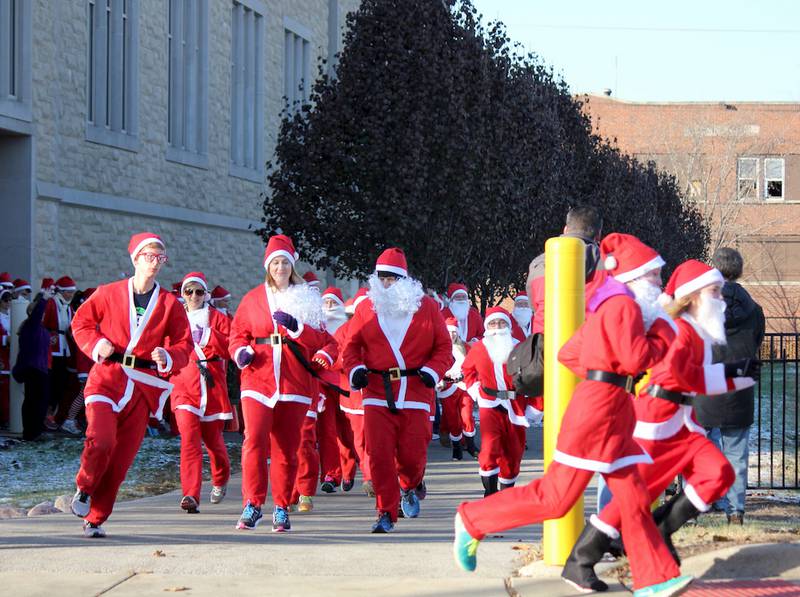 Participants in the Joliet Township High School Alumni Association Santa Run (5K fun run) and Santa Stroll (one-mile walk) received five-­piece Santa suits to wear during Saturday's race/walk. The race began at the Joliet Central High School campus, continued through Joliet City Center and ended with a party at the Joliet Central High School gymnasium.