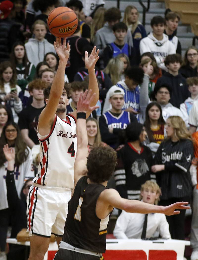 Huntley's Ian Ravagnie shoots the ball over Jacobs' Ben Jurzak during a Fox Valley Conference boys basketball game Tuesday, Jan. 24, 2023, at Huntley High School.