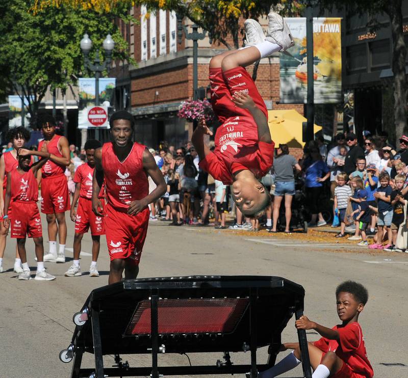 he Jesse White Tumblers entertain the the crowd along LaSalle St Sunday during the Fall Festival Parade in Ottawa.