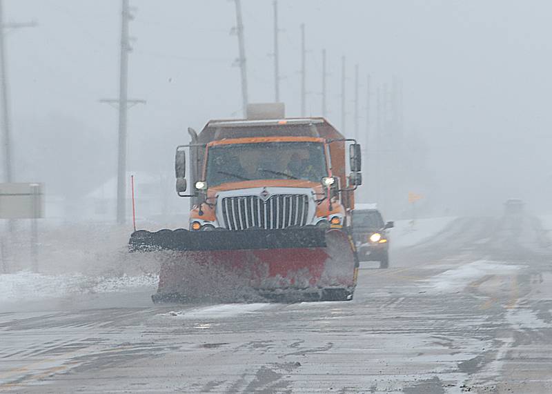 A snow plow removes snow and slush near the intersection of Illinois Route 71 and Illinois Route 178 on Wednesday, Jan. 25, 2023 near Utica.