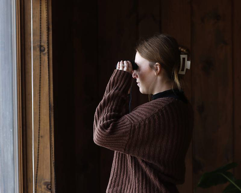 Bri Roeser looks out of the windows at the prairie for deer Tuesday, Oct. 18, 2022, at the McHenry County Conservation District's Prairieview Education Center in Silver Creek Conservation Area. The center, located at 2112 Behan Road in Crystal Lake, has reopened, to the public on Tuesdays and Thursdays and to school groups, after being closed for since the beginning of the pandemic.