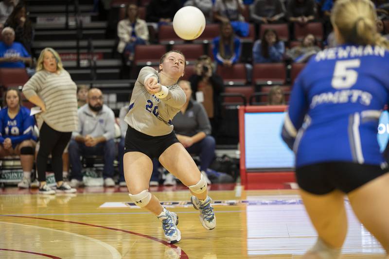 Newman’s Addison Foster plays a serve Friday, Nov. 11, 2022 in a class 1A volleyball semifinal against Aquin.