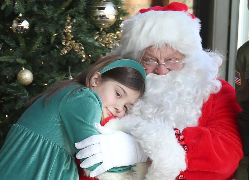 Amara Goskusky hugs Santa. Claus at the Auditorium Ballroom on Saturday, Dec. 7, 2024 downtown La Salle. The event is part of the Miracle on First Street celebration.